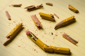 Shattered pencil fragments on a yellow legal pad, perhaps symbolizing writer's block